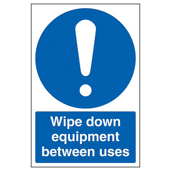 The My Store "Wipe Down Equipment Between Uses" sign features a large white exclamation mark above clear white text on a blue background, reminding staff to maintain Covid-secure hygiene by cleaning equipment between uses.